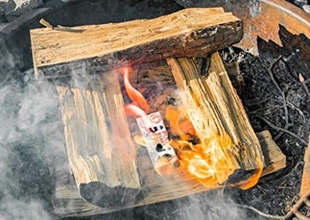 the lit fire starter and wood catching on fire
