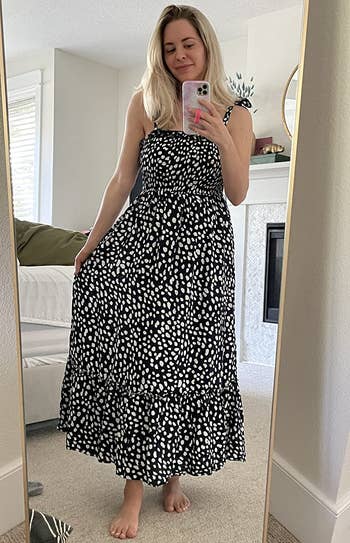 reviewer wearing the black dress with white polka dots