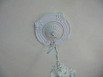 The medallion on a ceiling  around a chandelier base