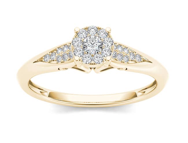 the gold round cluster diamond ring with diamonds in the center and on each side of the center diamond