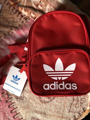 reviewer photo of red mini Adidas backpack