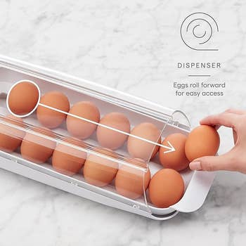 Egg dispenser with rows of eggs, designed to roll eggs forward for easy access