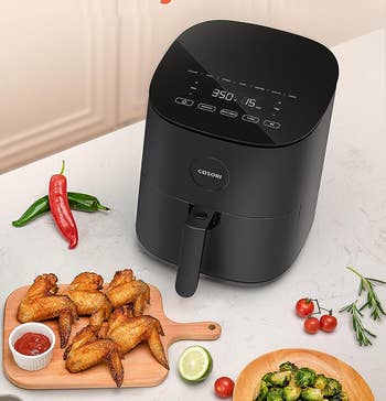 the black air fryer sitting on a countertop