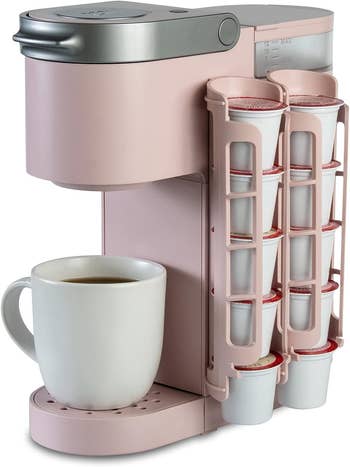 The pink dispenser which holds 10 coffee pods on side of coffee machine