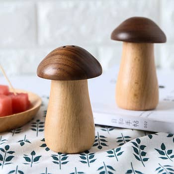 Two mushroom shaped wooden pieces on a counter