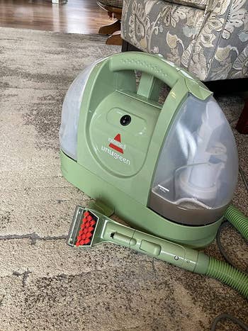 Portable carpet cleaner connected  a rug, perfect  for spot   cleaning and tiny  areas, featuring a hand-held nozzle