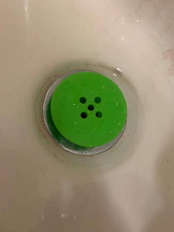 reviewer's green TubShroom in the drain