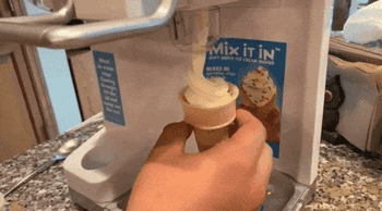 gif of reviewer using the soft serve machine