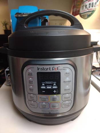 reviewer's Instant Pot on kitchen counter with function labels for pressure cooking and various foods