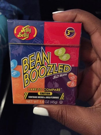 A reviewer holding the box of jelly beans