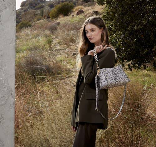 model holding the handbag over her shoulder 