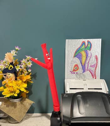 the inflatable tube guy on a desk