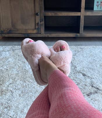 A different reviewer wearing the slippers in pink
