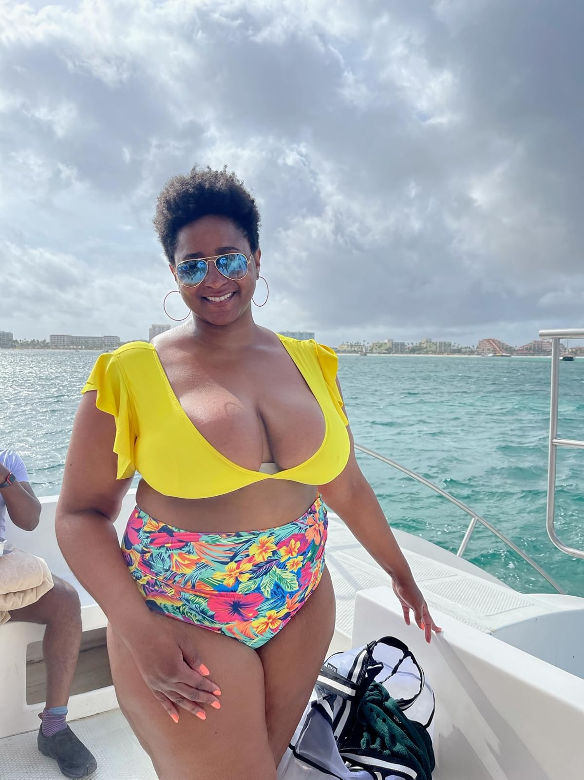 reviewer wearing the yellow suit with colorful bottoms
