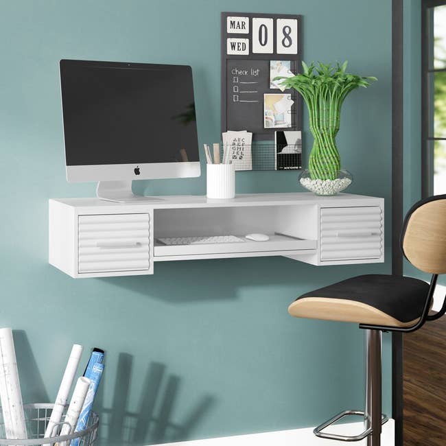 white floating desk with two drawers and open storage