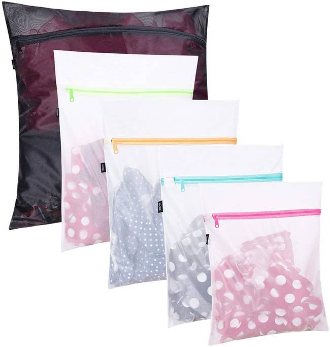 set of five different-sized mesh laundry bags with clothes inside
