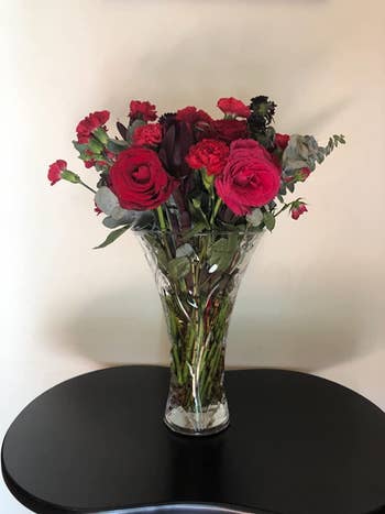 Reviewer image of product with red roses inside on top of black table