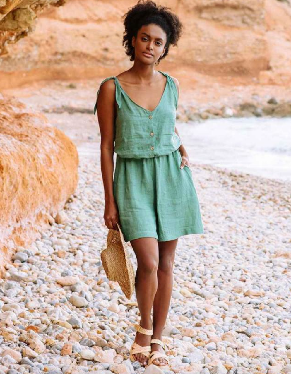 model wearing green romper
