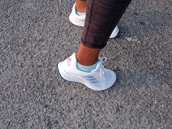Reviewer showing back view of Adidas sneakers