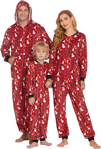 a family in red one piece fleece pajamas