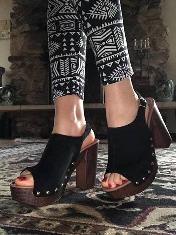 model in black peep toe platform heeled clogs