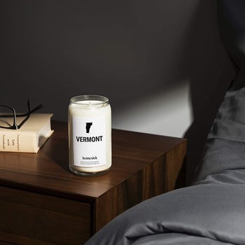 white candle with a glass jar that reads 
