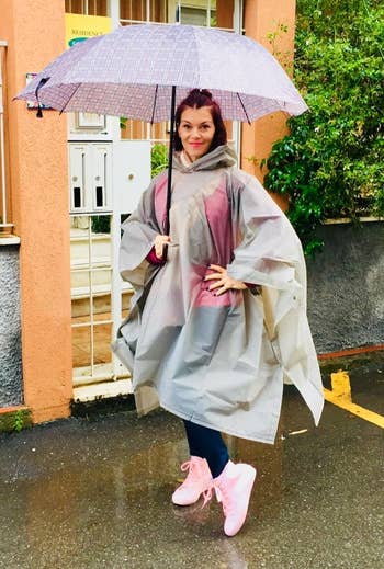 reviewer holding an umbrella and wearing the pink high-tops