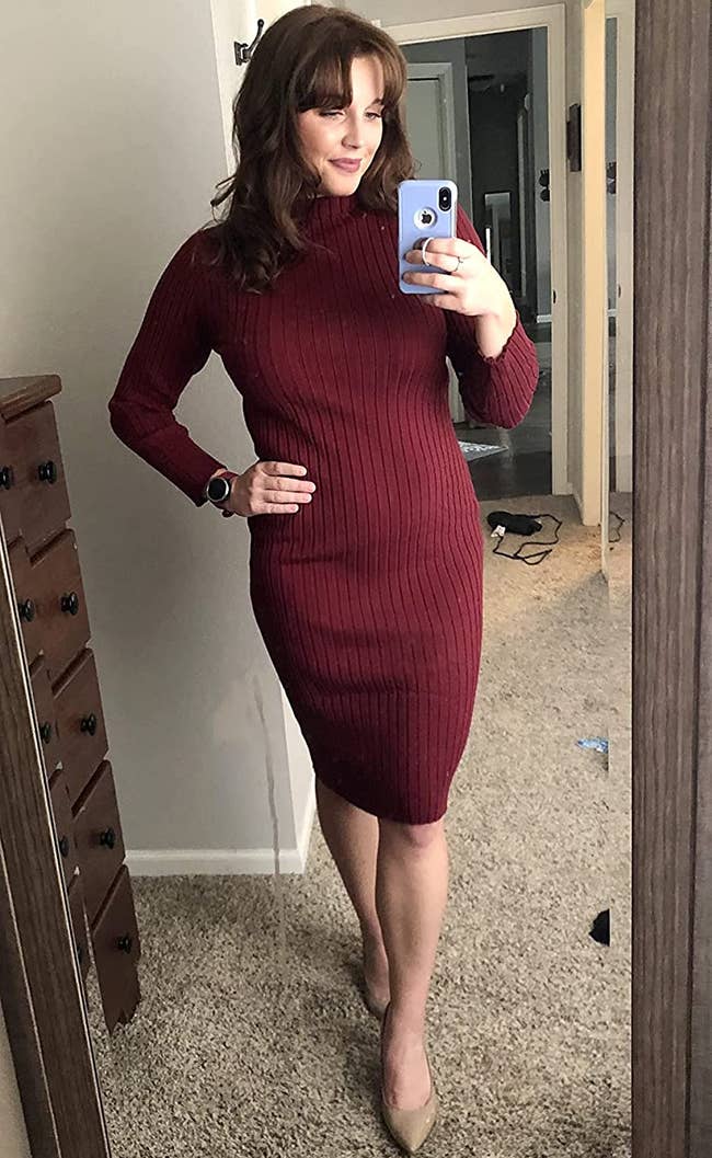 reviewer wearing the burgundy dress with tan heels
