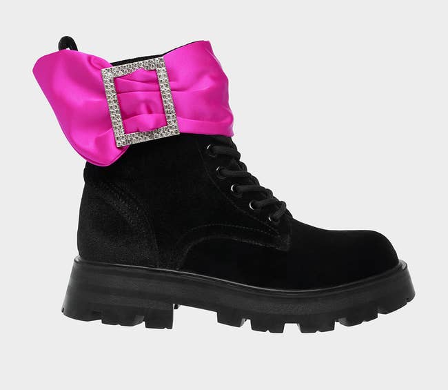 black thick sole combat boots with ribbon and buckle detail around ankle