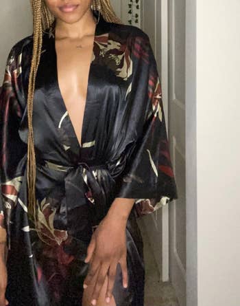 a reviewer wearing the kimono robe in black with a floral print 