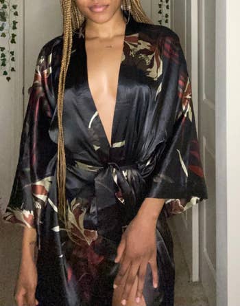 a reviewer wearing the kimono robe in black with a floral print 