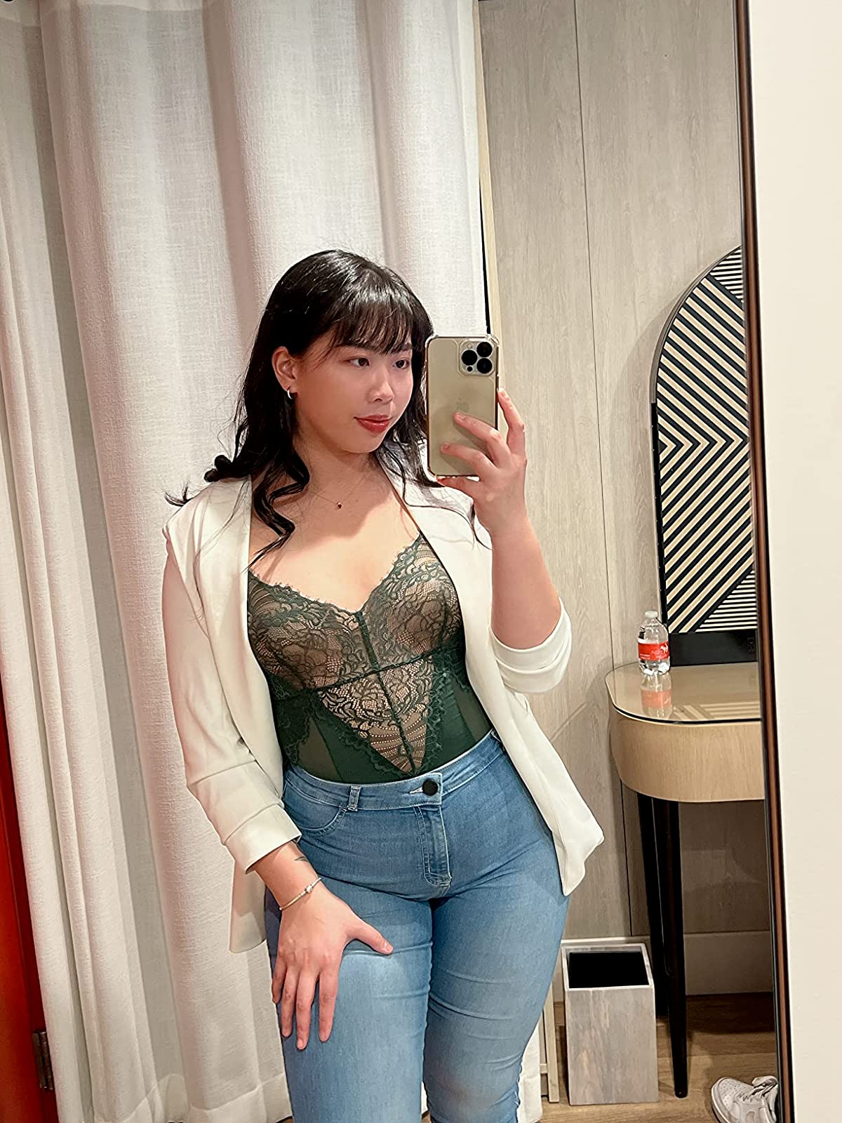 A reviewer wearing the invisible pasties under a sheer lace bodysuit