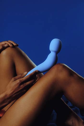 Model posing with blue wand vibrator