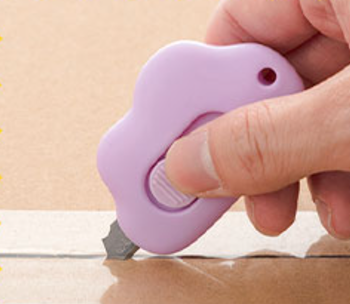 Model using a purple cloud shaped knife to open a package 
