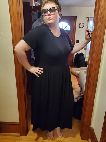 a reviewer wearing the short sleeve maxi dress in black