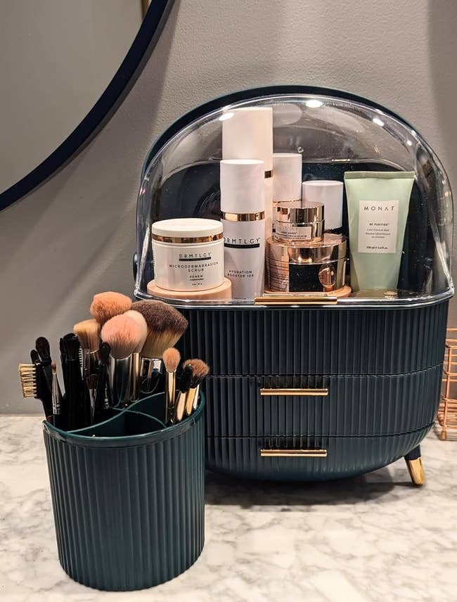 Reviewer's makeup organizer showing all the products inside and the brush container
