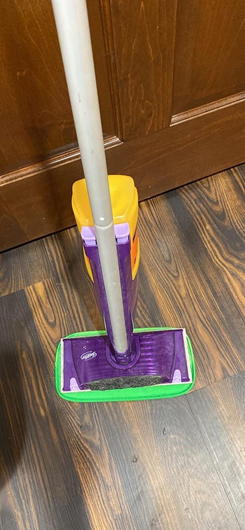 reviewer pic of the green pad attached to a Swifter mop