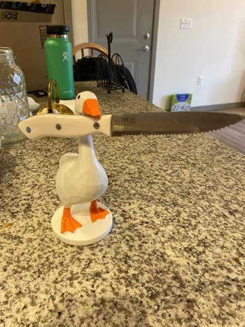 Goose-shaped weapon  holder connected  a room  countertop