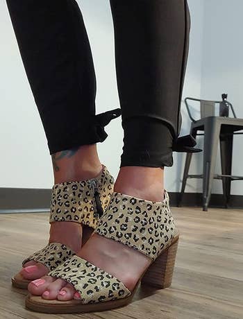 image of reviewer wearing the cheetah print sandals