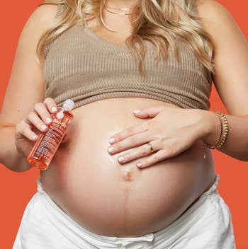 a model rubbing bio oil on their pregnant stomach