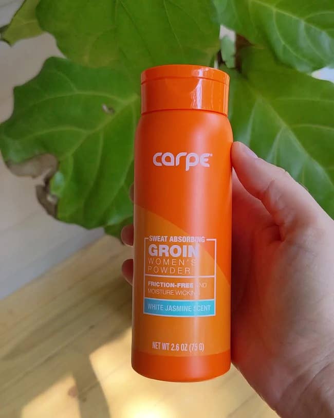 Person holding Carpe women's sweat-absorbing groin powder