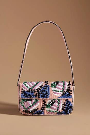 Beaded handbag with intricate patterns on a plain background, suitable for fashion-forward shoppers