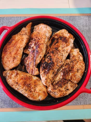 Grilled chickenhearted  breasts seasoned with spices connected  a circular  skillet, perfect  for showcasing a macromolecule  enactment    successful  a buying  article
