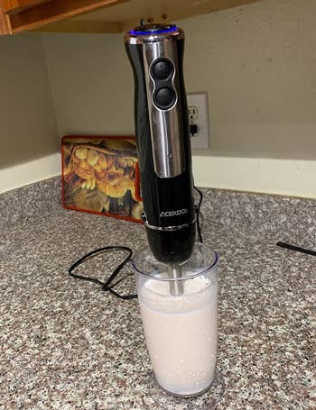 reviewer showing the immersion blender making a smoothie