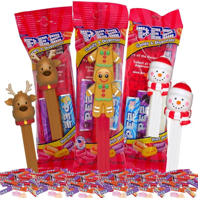 the reindeer, gingerbread man, and snowman Pez candy dispensers with little packs of Pez candy around them 