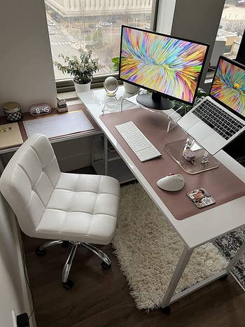 reviewer pic of a work from home setup with the monitor on the desk