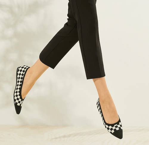 model in black and white check cap toe flats