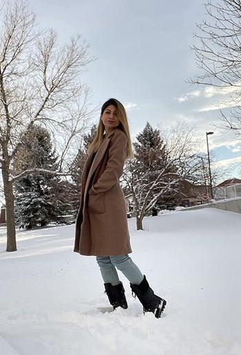 A reviewer wearing a khaki colored coat