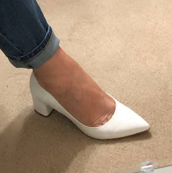 Image of reviewer wearing white heels