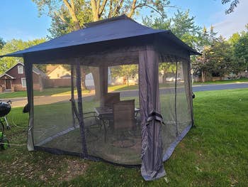 Reviewer's gazebo in gray with the nets down covering the enclosure 